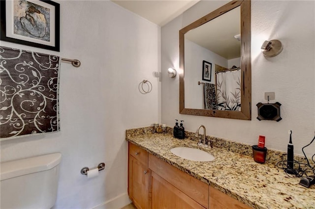 full bathroom featuring vanity and toilet