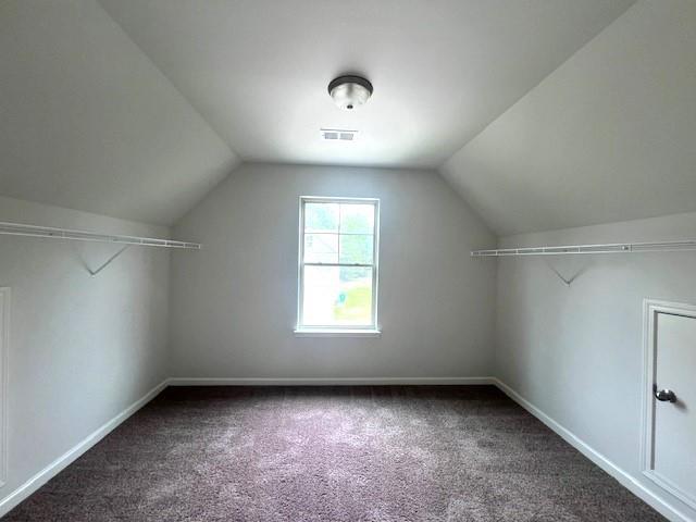 2469 Osceola Rd, Lithonia, GA 30058 - additional living space featuring carpet floors, vaulted ceiling, and baseboards