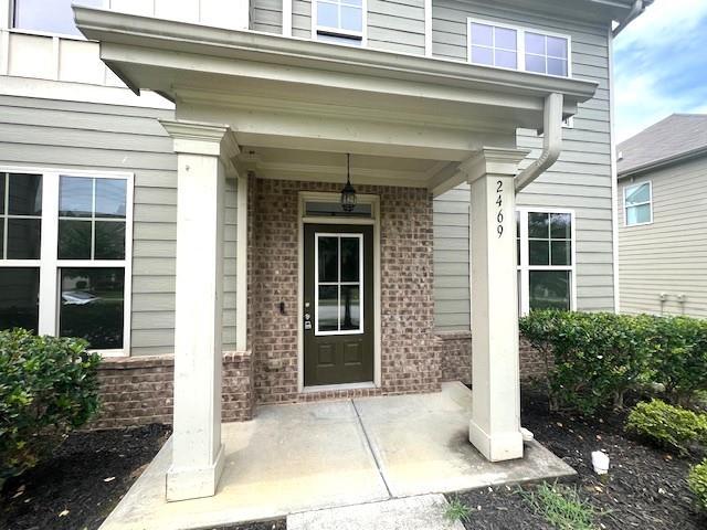 2469 Osceola Rd, Lithonia, GA 30058 - property entrance with brick siding and a porch