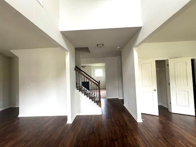 2469 Osceola Rd, Lithonia, GA 30058 - entrance foyer with stairway, wood finished floors, and baseboards