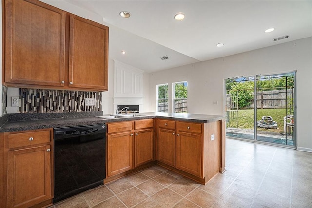 7761 Parkside Dr, Lithia Springs, GA 30122 - kitchen with black dishwasher, a sink, a peninsula, brown cabinetry, and recessed lighting