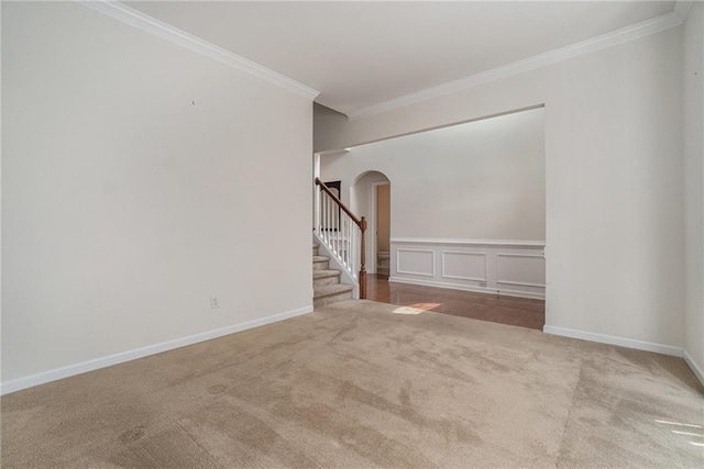 7761 Parkside Dr, Lithia Springs, GA 30122 - unfurnished room with carpet flooring, arched walkways, ornamental molding, stairway, and baseboards