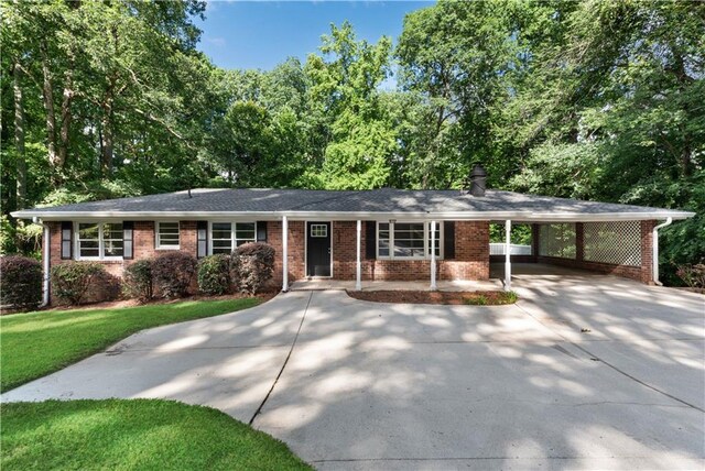 single story home featuring a carport