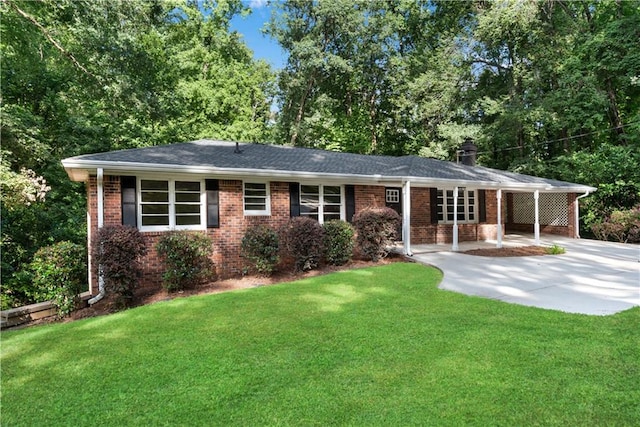 ranch-style house featuring concrete driveway, a chimney, a front lawn, a carport, and brick siding