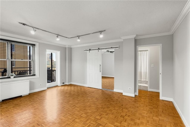 unfurnished room with ornamental molding, baseboards, and a textured ceiling