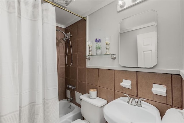 bathroom featuring visible vents, shower / bathtub combination with curtain, tile walls, and toilet