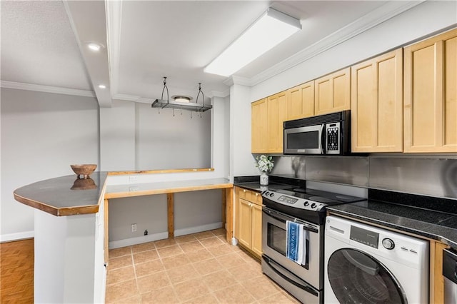 kitchen with dark countertops, washer / dryer, stainless steel appliances, and light brown cabinetry