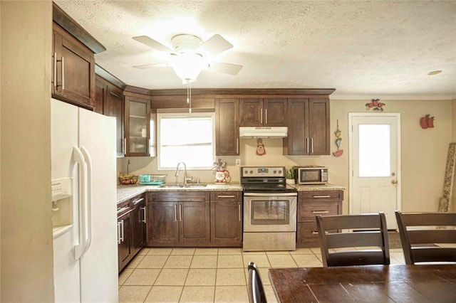 kitchen with sink, a healthy amount of sunlight, stainless steel appliances, crown molding, and light tile patterned flooring