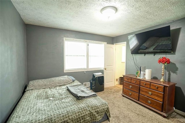 carpeted bedroom with a textured ceiling