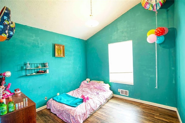 bedroom with wood-type flooring and vaulted ceiling