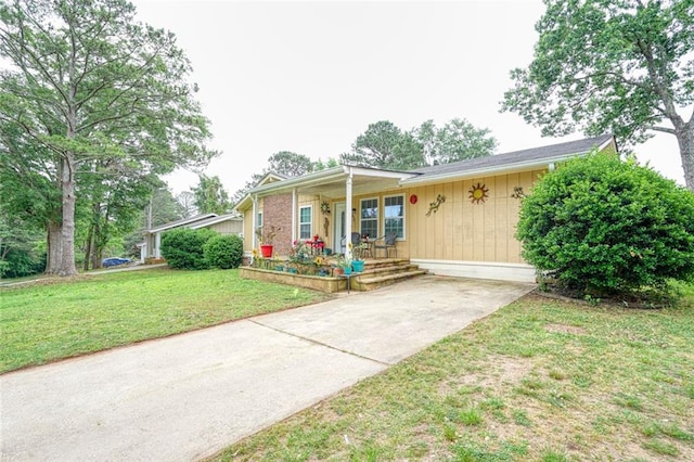 single story home with a front lawn and covered porch