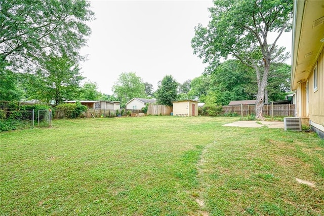 view of yard with a storage shed and a patio area