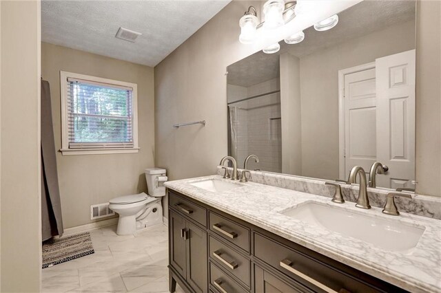 537 Raven Springs Trl, Stone Mountain, GA 30087 - bathroom featuring double vanity, marble finish floors, a shower with curtain, and a textured ceiling