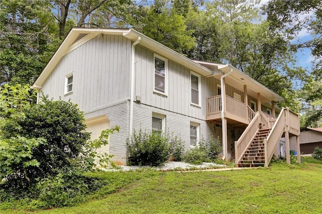 537 Raven Springs Trl, Stone Mountain, GA 30087 - rear view of property featuring stairs, brick siding, a yard, a garage, and board and batten siding