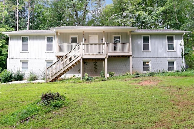 537 Raven Springs Trl, Stone Mountain, GA 30087 - back of house with a lawn, stairs, brick siding, covered porch, and board and batten siding