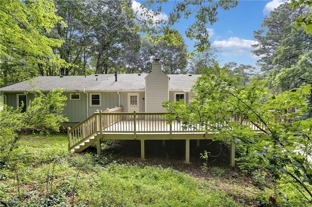 537 Raven Springs Trl, Stone Mountain, GA 30087 - back of property featuring a wooden deck, a chimney, roof with shingles, and stairway