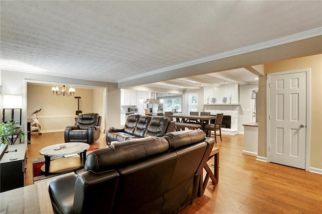537 Raven Springs Trl, Stone Mountain, GA 30087 - living room with a chandelier, ornamental molding, light wood-type flooring, a textured ceiling, and a stone fireplace