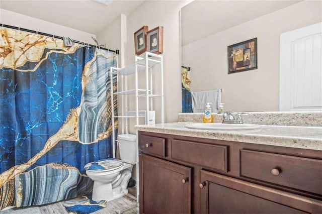 bathroom featuring vanity and toilet