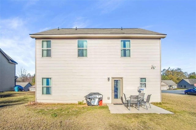 back of house featuring a lawn and a patio