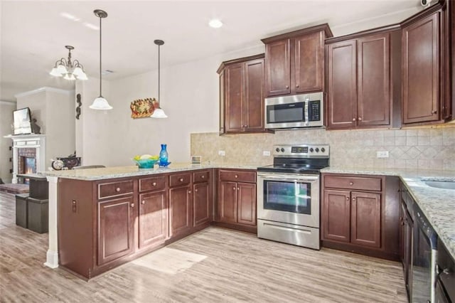 kitchen with kitchen peninsula, decorative backsplash, light wood-type flooring, stainless steel appliances, and pendant lighting