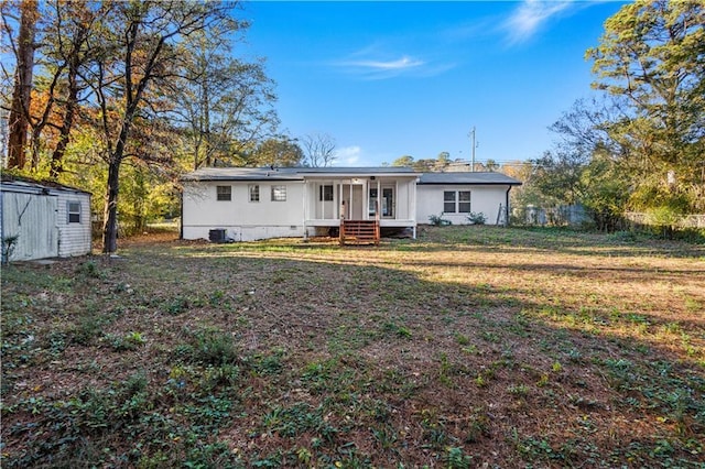 view of front of property featuring a storage shed, an outdoor structure, fence, crawl space, and a front lawn