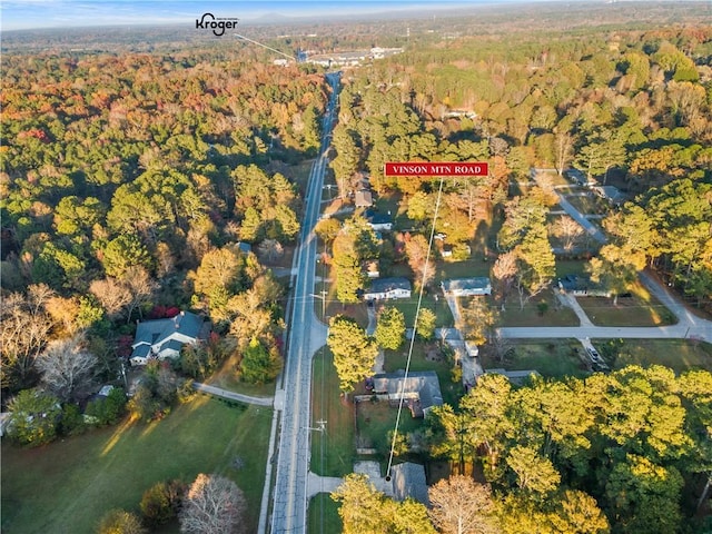 birds eye view of property with a view of trees