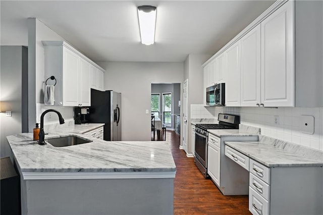 1185 Charter Club Dr, Lawrenceville, GA 30043 - kitchen with appliances with stainless steel finishes, a sink, dark wood-style flooring, and light stone counters