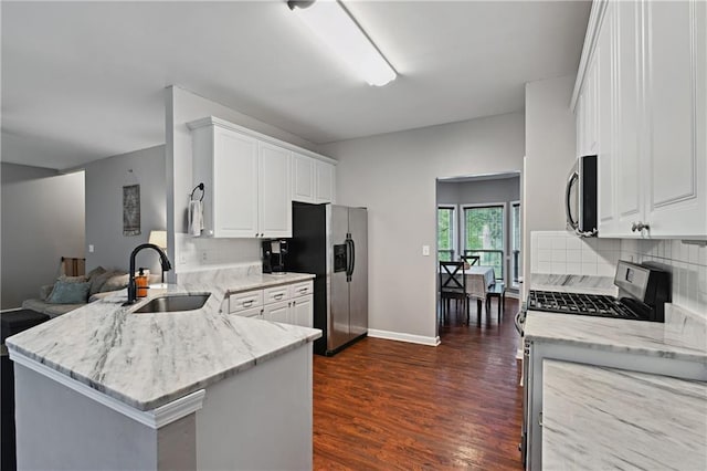 1185 Charter Club Dr, Lawrenceville, GA 30043 - kitchen featuring a sink, appliances with stainless steel finishes, a peninsula, light stone countertops, and backsplash