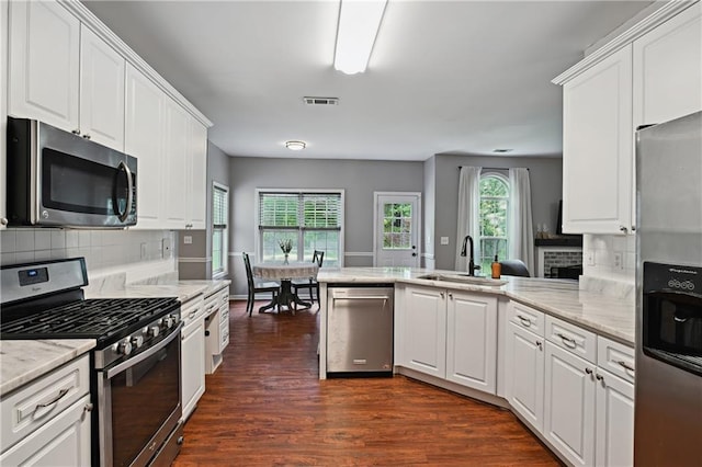 1185 Charter Club Dr, Lawrenceville, GA 30043 - kitchen with stainless steel appliances, a sink, dark wood-type flooring, and white cabinets