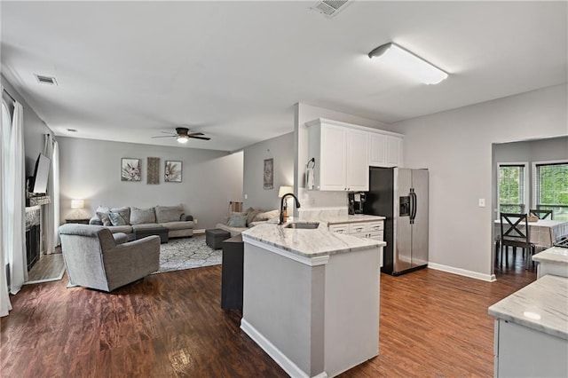 1185 Charter Club Dr, Lawrenceville, GA 30043 - kitchen featuring stainless steel refrigerator with ice dispenser, a sink, a ceiling fan, white cabinets, and light stone counters