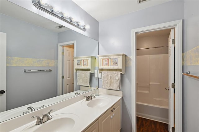 1185 Charter Club Dr, Lawrenceville, GA 30043 - full bath with double vanity, wood finished floors, and bathing tub / shower combination
