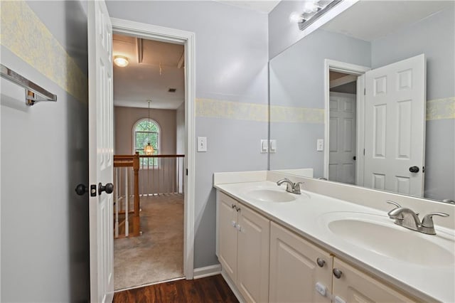 1185 Charter Club Dr, Lawrenceville, GA 30043 - bathroom with wood finished floors, double vanity, and baseboards