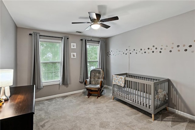 1185 Charter Club Dr, Lawrenceville, GA 30043 - carpeted bedroom featuring baseboards, a ceiling fan, and a nursery area