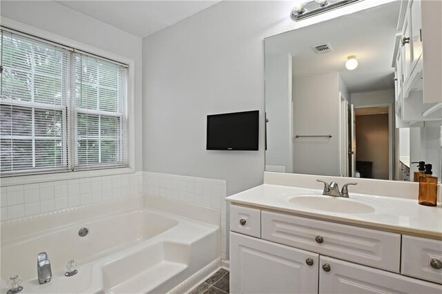 1185 Charter Club Dr, Lawrenceville, GA 30043 - bathroom featuring a garden tub, vanity, and tile patterned floors