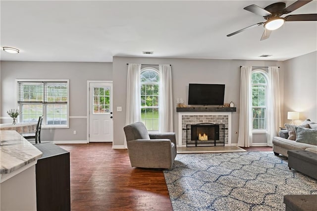 1185 Charter Club Dr, Lawrenceville, GA 30043 - living room featuring healthy amount of natural light, dark wood-type flooring, a ceiling fan, and baseboards