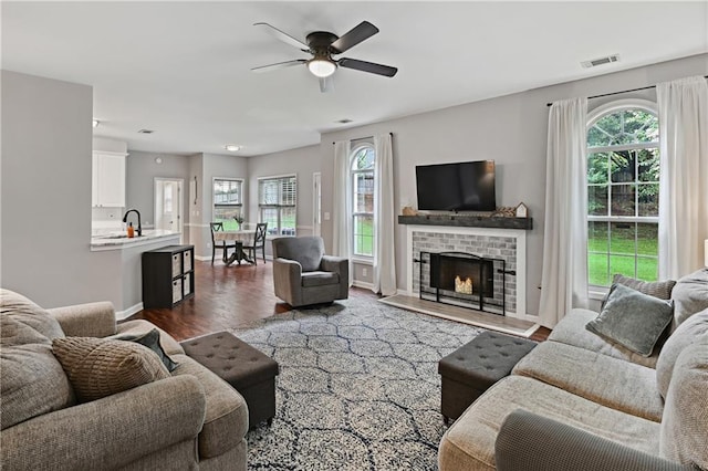 1185 Charter Club Dr, Lawrenceville, GA 30043 - living area with ceiling fan, dark wood-style flooring, baseboards, and a fireplace