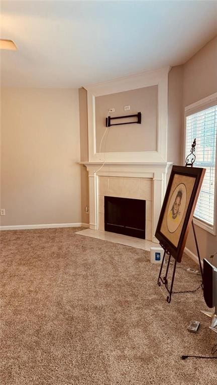 unfurnished room featuring a fireplace and carpet