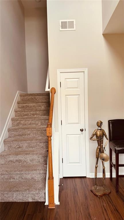 stairs featuring hardwood / wood-style flooring