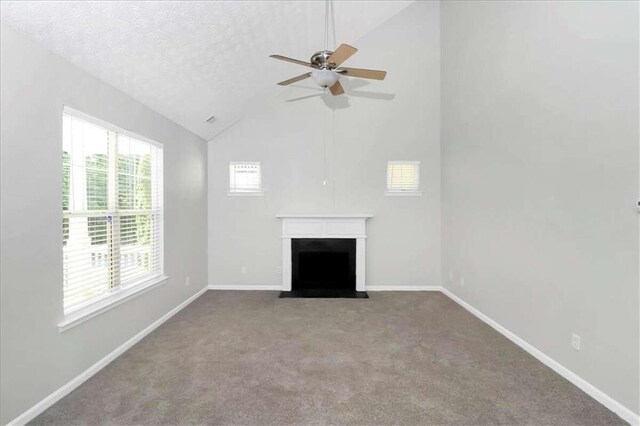 unfurnished living room featuring ceiling fan, a textured ceiling, light carpet, and high vaulted ceiling