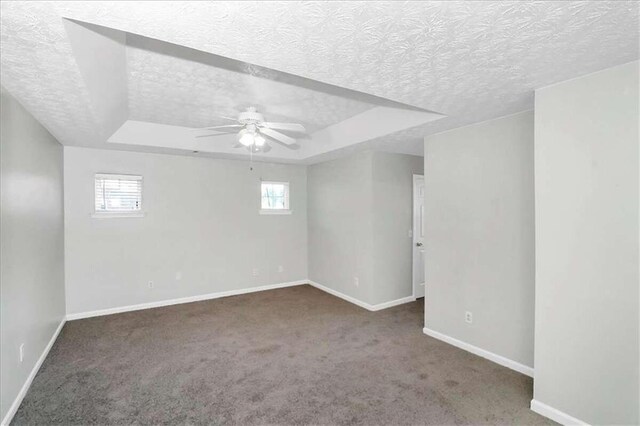 unfurnished room featuring a textured ceiling, ceiling fan, and a wealth of natural light