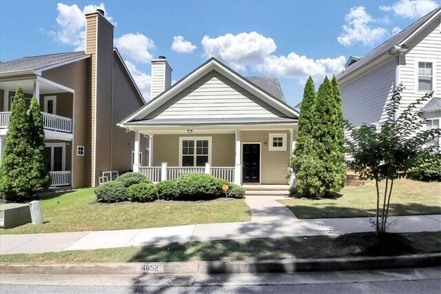 view of front of home featuring a front yard and covered porch