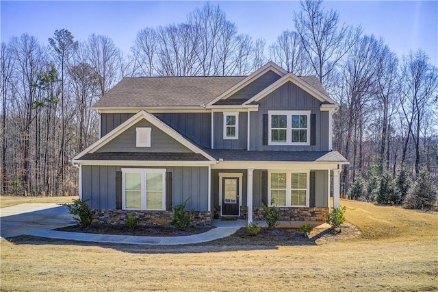 craftsman inspired home with board and batten siding and a shingled roof