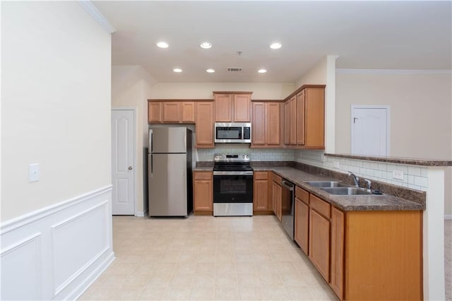 529 Ridge View Xing, Woodstock, GA 30188 - kitchen with stainless steel appliances, a sink, dark countertops, crown molding, and decorative backsplash