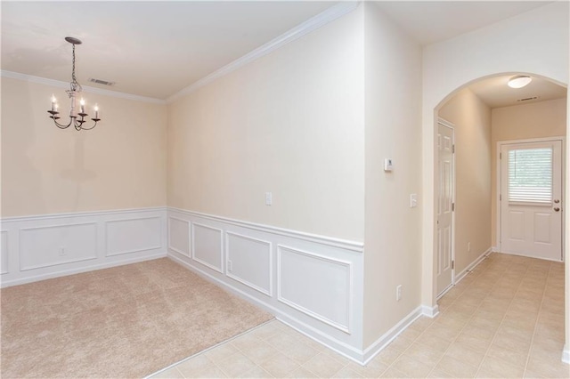 529 Ridge View Xing, Woodstock, GA 30188 - spare room featuring arched walkways, a chandelier, a wainscoted wall, ornamental molding, and a decorative wall