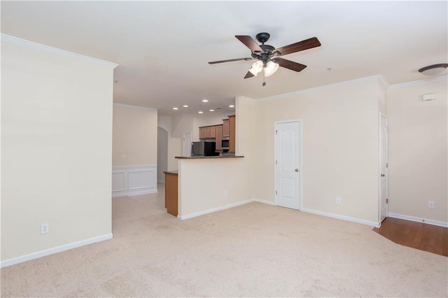 529 Ridge View Xing, Woodstock, GA 30188 - unfurnished living room with a ceiling fan, crown molding, light colored carpet, recessed lighting, and arched walkways