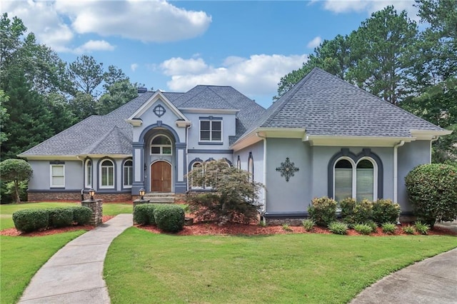 1213 Grande Vw, Loganville, GA 30052 - view of front facade with stucco siding and a front yard