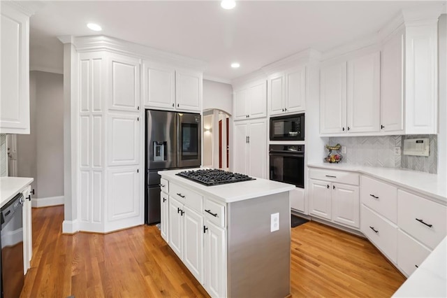 1213 Grande Vw, Loganville, GA 30052 - kitchen with black appliances, recessed lighting, light countertops, light wood-style floors, and white cabinetry