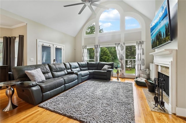 1213 Grande Vw, Loganville, GA 30052 - living room featuring a ceiling fan, high vaulted ceiling, wood finished floors, and a premium fireplace