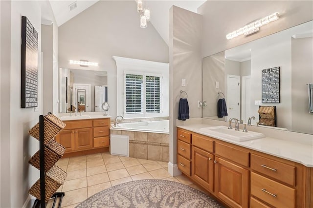 1213 Grande Vw, Loganville, GA 30052 - full bath featuring tile patterned flooring, a garden tub, two vanities, and high vaulted ceiling