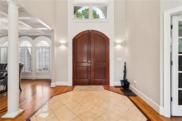 1213 Grande Vw, Loganville, GA 30052 - entrance foyer featuring wood finished floors, plenty of natural light, beam ceiling, and coffered ceiling